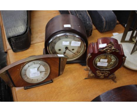 A 1940s Enfield mantle clock, a 1950s teak veneered Metamec mantle clock, together with a Rococo style gilt mounted mantle cl