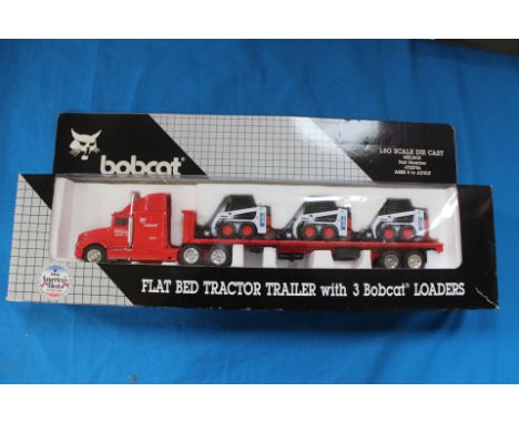 Bobcat 1/50 scale diecast flat bed tractor, trailer with three bobcat loaders, boxed.