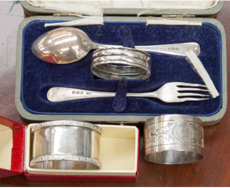 A George V sterling silver cased christening set of spoon, fork and napkin ring, Levi & Salaman Birmingham 1921, together wit