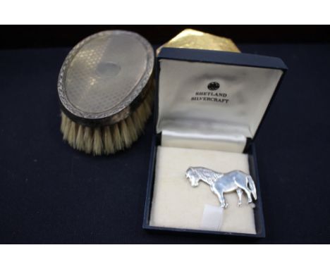 A silver back engine turned decoration small hair brush, Birmingham 1927, Edwardian napkin ring, Shetland pony brooch, cuffli