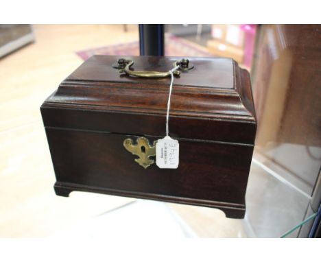 A George III mahogany tea caddy, c.1760, caddy top with brass swing handle, brass escutcheon, fitted interior with triple div