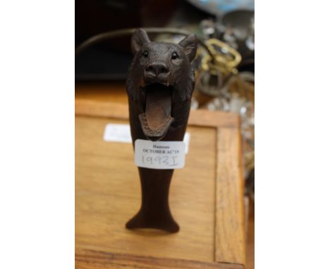 A 19th Century carved Black Forest bear nut cracker, set with glass eyes.