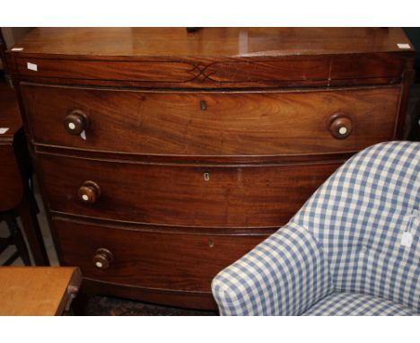 A George III mahogany bow fronted chest of drawers, circa 1810, fitted with three long graduated drawers, raised on bracket f