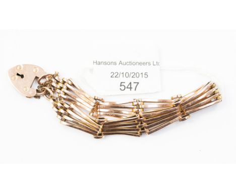 A rose gold four bar gate bracelet with padlock clasp, stamped '9ct', 12.5 grams