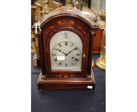 An early 20th Century mahogany bracket clock, silver dial and Roman numerals, with machined inlay to front.