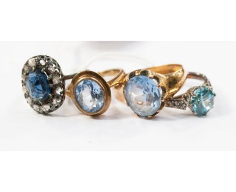 A ring set blue topaz, a sapphire and diamond ring and two rings set blue stones.