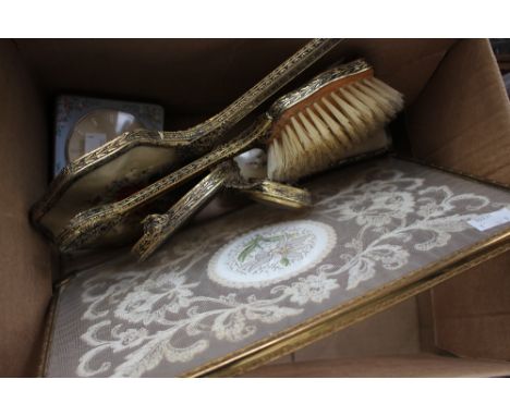 A 1950's lace and embroidery inset dressing table tray with associated brushes, hand mirror and clock, a 1960's Westclox ladi