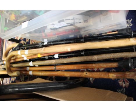 An embossed silver topped walking stick, with a brass horses head, section walking stick and seven further walking sticks. (9