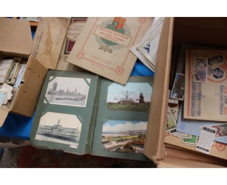 A postcard album containing approx seventy postcards, circa 19th Century - 1935, including comic cartoon illustrations, steam
