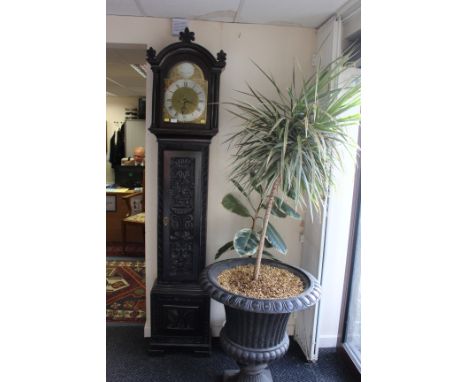 A 19th century oak cased long case clock, the case later ebonised and carved. The 11 inch dial with silvered chapter ring and