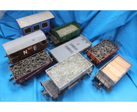 A group of eight G scale model railway wagons