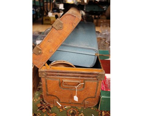 A tin trunk and contents to include copper based posher and suitcase.