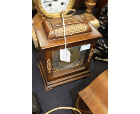 A 20th Century wooden mantle clock with key.