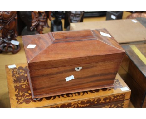 An early 19th Century mahogany tea caddy of sarcophagus form, with twin compartment interior and mixing bowl.