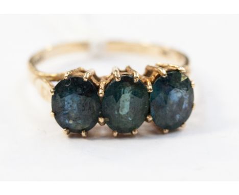 A 9ct three stone sapphire ring, claw set, three oval cut blue-green sapphires, approximately 2.95 ct total weight.