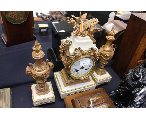 A French gilt metal and marble garniture clock set, comprising eight day mantle clock and two pedestal urns. (3)









