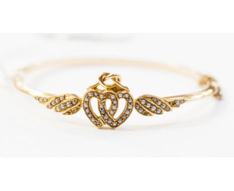 A yellow metal and seed pearl bangle, 7.8 grams.