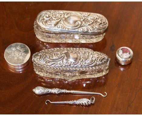Four early twentieth century silver boxes and two silver button hooks.