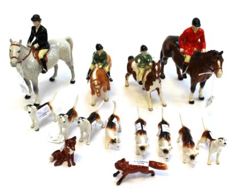 A Beswick hunting set including four riders on horses, two foxes and eight dogs.