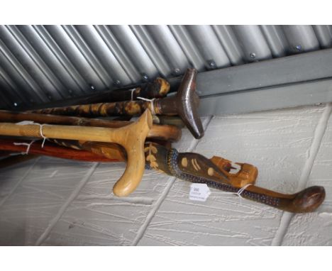 A collection of walking sticks, comprising various sticks of various designs, including an ash pit deputy's stick, souvenir s