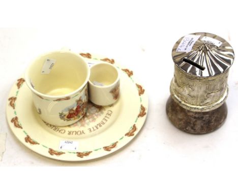 A Royal Doulton Bunnykins egg cup, plate and cup and a metal money box with musical. (4)