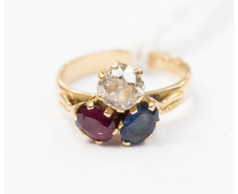 A ruby, sapphire and diamond trefoil ring, claw set old cut diamonds of approximately 0.75ct in cluster with oval cut ruby an