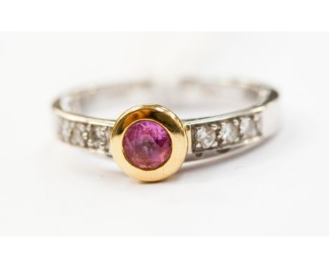 An 18ct white gold ring with six chip diamonds on shoulders and pink sapphire centre, mounted in 18ct gold.