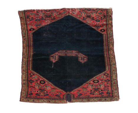 Rare Malayir Saddle Rug, circa 1910 The deep indigo lozenge field with central boat shaped panel framed by tomato red spandre