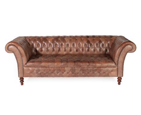 A Victorian Style Buttoned Brown Leather Chesterfield Sofa, modern, with rounded arms and overstuffed seat, on turned foreleg