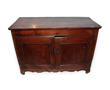 An Early 18th Century French Provincial Fruitwood Sideboard, the canted rectangular top above two moulded cupboard doors encl