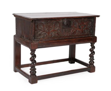 An 18th Century Oak Bible Box, dated and initialled 1725 JH, the boarded lid enclosing a candle box with two small drawers ab