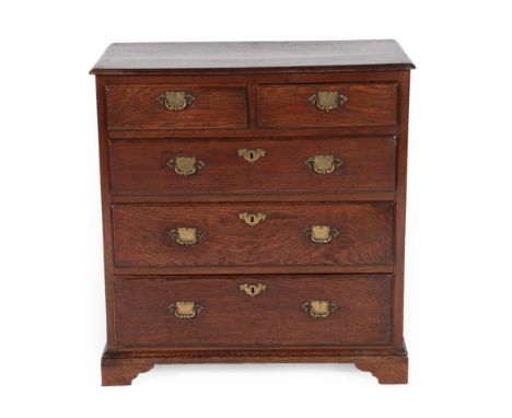 An Early 18th Century Oak Straight Front Chest, the moulded top above two short and three long graduated drawers with brass e