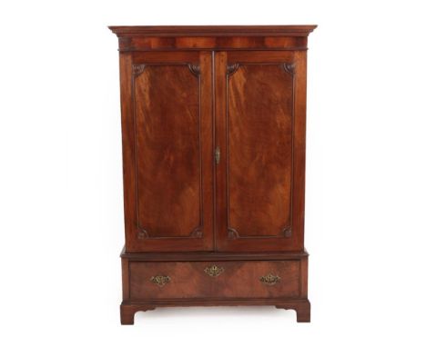 A Late George III Mahogany Dwarf Linen Cupboard, early 19th century, the moulded dentil cornice above two moulded cupboard do