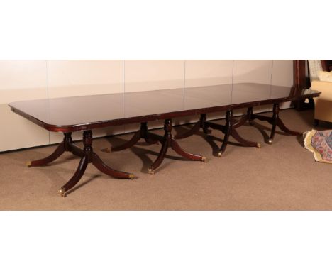 ~ A Reproduction Mahogany Eight Pillar Dining Table, with two additional leaves, on conforming turned supports with wavy shap