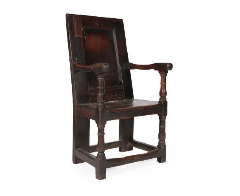 A 17th Century Joined Oak Armchair, bearing date 1665, the back support with moulded panel above a nailed and boarded seat, o