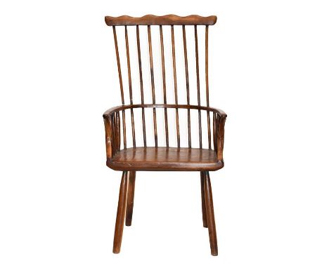 A Yewwood Stick-Back Armchair, the comb shaped top rail above curved armrests and a solid yewwood seat, 56cm by 36cm by 109cm