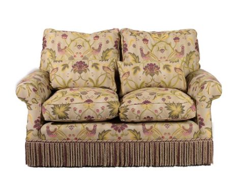 ~ A Two-Seater Feather-Filled Sofa, modern, covered in floral green fabric decorated with exotic birds, with six removable cu