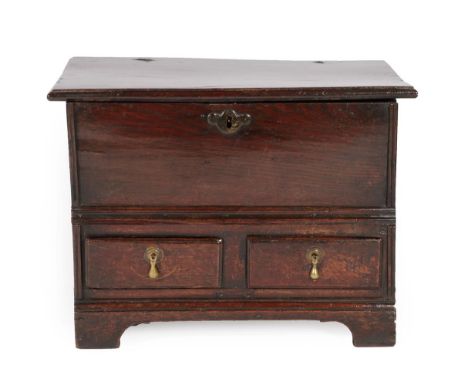 An Early 18th Century Oak Chest, the hinged lid above two small drawers and an arched apron with bracket feet (good colour), 