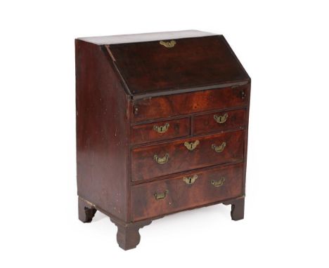 A George II Walnut and Feather-Banded Bureau, 2nd quarter 18th century, of small proportions, the feather-banded fall enclosi