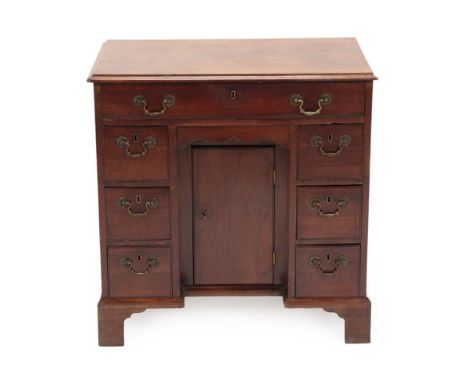 A George III Mahogany Kneehole Dressing Table, late 18th century, the moulded top above a long frieze drawer with small slidi