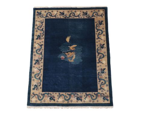 Chinese Carpet, circa 1920 The deep indigo field with central panel containing a dragon enclosed by mushroom borders of furth