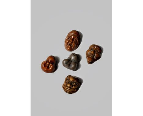 FIVE JAPANESE MASK NETSUKE MEIJI 1868-1912 Variously carved as two Okame, one signed Hidemasa, an elderly woman opening her m