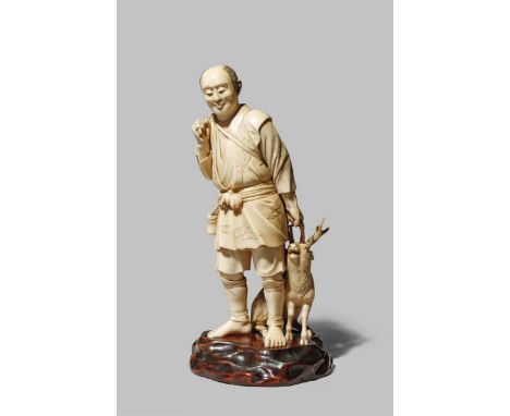 A JAPANESE IVORY OKIMONO MEIJI 1868-1912 Depicting a man returning from the hunt, a bow and arrow slung over his shoulder and