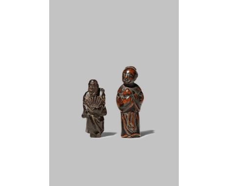 TWO JAPANESE WOOD NETSUKE EDO 1615-1868 Both depicting standing figures, the first holding a fan and lifting the hem of his r