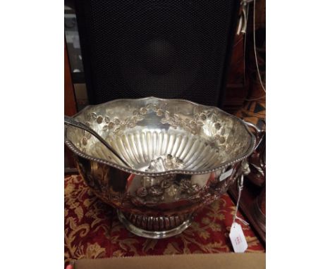 A large silver-plated punch bowl having fluted and floral decoration with ladle 