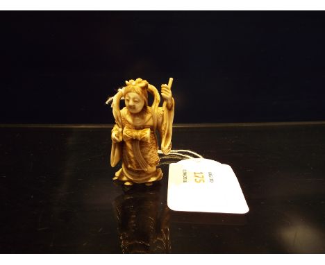 A 19thC Japanese carved ivory 'Okimono' of a Geisha musician in traditional robes playing drums, unsigned 5.5 cm high