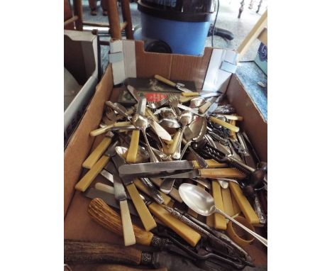 A box of assorted vintage cutlery to include horn handled carving set, bone handled silver plate, boxed butter spreaders etc