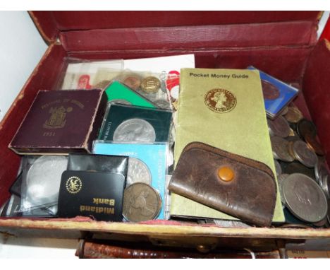 A vintage brown leather suitcase and a selection of assorted British coinage