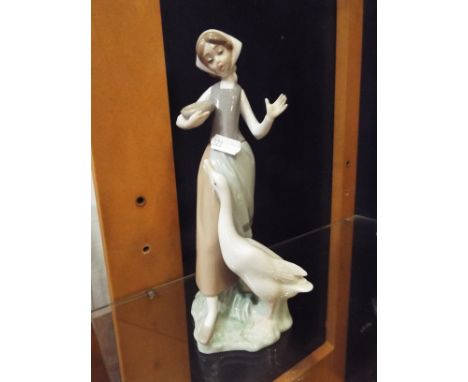 A Lladro figurine 'Girl With Goose', marks to base No 1052, 10" high