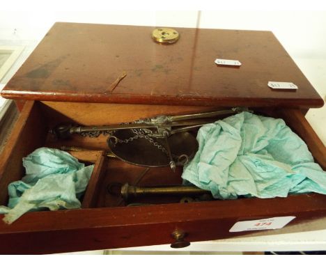 A set of late 19thC/early 20thC brass chemist's scales and weight housed in a mahogany case